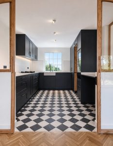 Cocina abierta al comedor con cerramiento acristalado de roble · reforma integral en Torrelodones